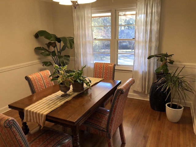 dining space with plenty of natural light, baseboards, and wood finished floors