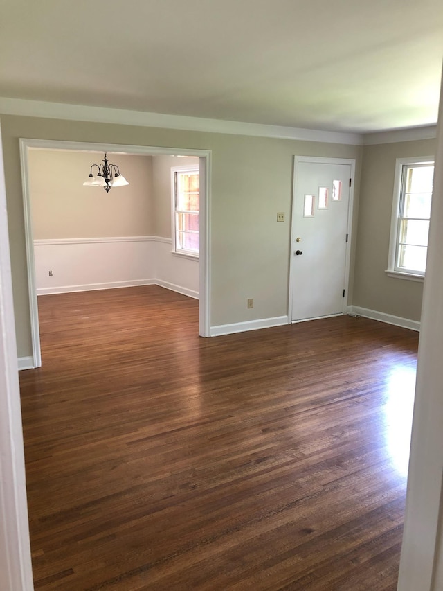 entrance foyer with baseboards, dark wood finished floors, and a healthy amount of sunlight