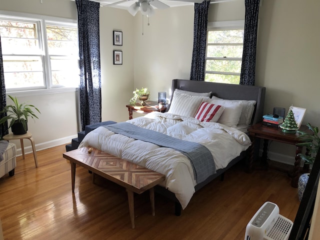 bedroom featuring baseboards and wood finished floors