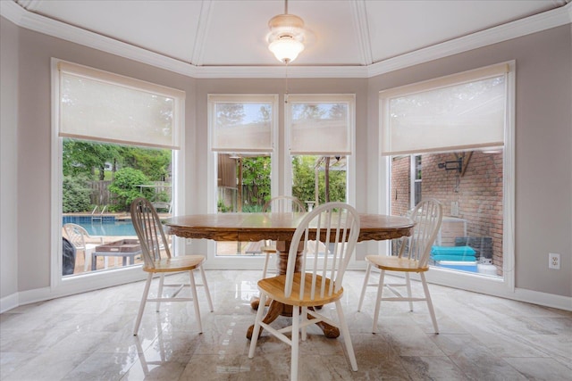 dining space featuring crown molding, baseboards, and a wealth of natural light