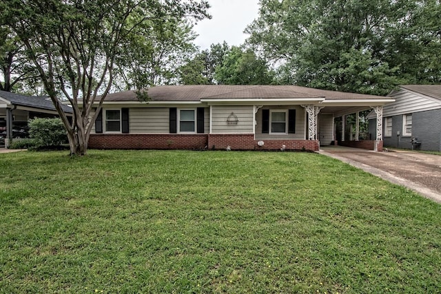 ranch-style house featuring brick siding, a carport, a front lawn, and concrete driveway
