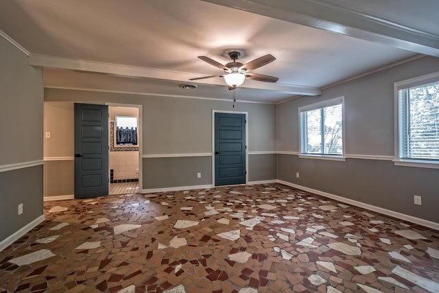 spare room featuring baseboards, ornamental molding, and ceiling fan