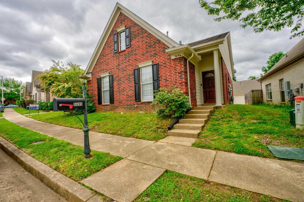 5699 Falling Bark Dr, Memphis, TN 38134 - view of front of property featuring a front lawn and brick siding