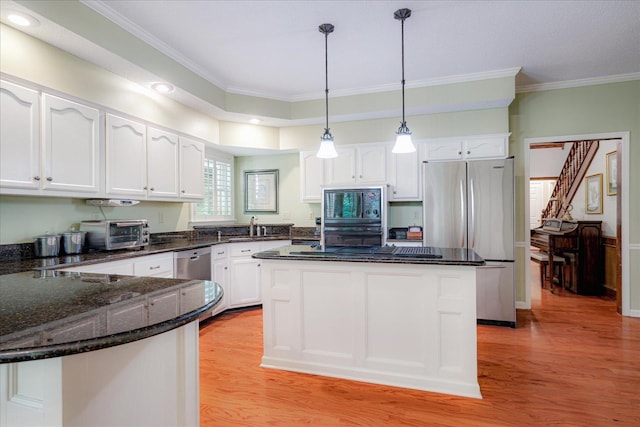 819 N Tree Dr, Collierville, TN 38017 - kitchen with white cabinets, appliances with stainless steel finishes, ornamental molding, and a toaster