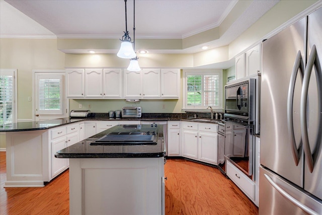 819 N Tree Dr, Collierville, TN 38017 - kitchen featuring crown molding, stovetop, freestanding refrigerator, and light wood finished floors