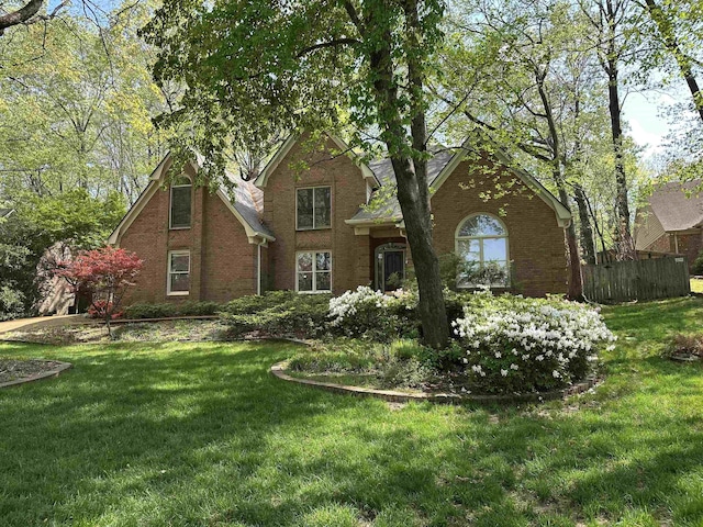 819 N Tree Dr, Collierville, TN 38017 - view of front facade featuring fence, a front lawn, and brick siding