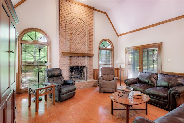 819 N Tree Dr, Collierville, TN 38017 - living room featuring crown molding, light wood finished floors, a brick fireplace, and high vaulted ceiling