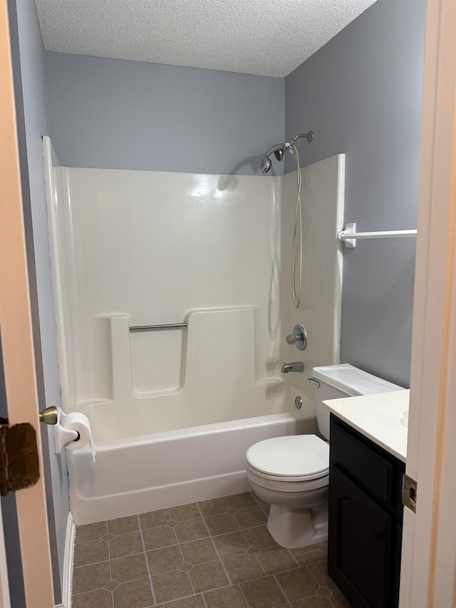 bathroom with bathtub / shower combination, vanity, toilet, a textured ceiling, and tile patterned floors