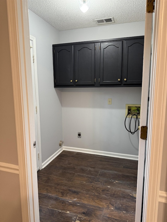 clothes washing area featuring electric dryer hookup, visible vents, cabinet space, dark wood-style floors, and hookup for a washing machine