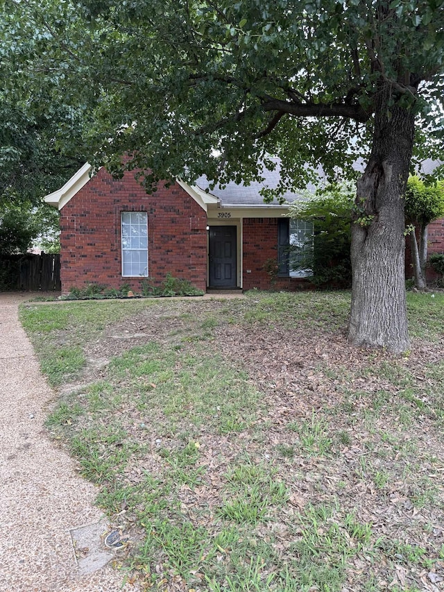 single story home with fence and brick siding