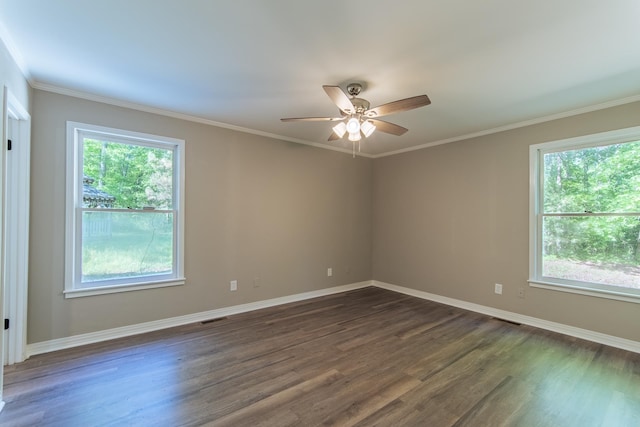 unfurnished room with visible vents, dark wood-style flooring, baseboards, and a wealth of natural light