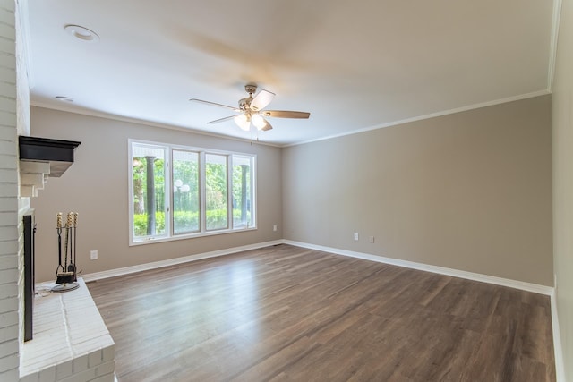 unfurnished living room featuring baseboards, a ceiling fan, a brick fireplace, and wood finished floors
