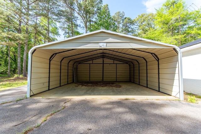 view of parking / parking lot with aphalt driveway and a carport
