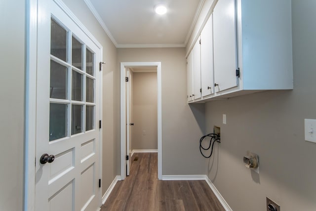 washroom featuring crown molding, baseboards, dark wood finished floors, cabinet space, and washer hookup