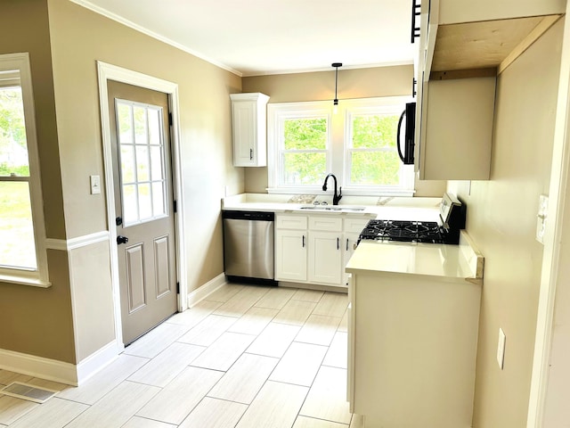 424 Tipton St S, Munford, TN 38058 - kitchen with dishwasher, a sink, baseboards, light countertops, and gas range oven