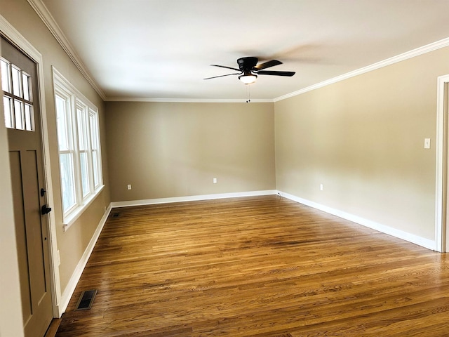 424 Tipton St S, Munford, TN 38058 - unfurnished room with crown molding, a ceiling fan, dark wood finished floors, and visible vents