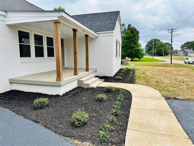 424 Tipton St S, Munford, TN 38058 - view of property exterior with roof with shingles, a lawn, a porch, and brick siding