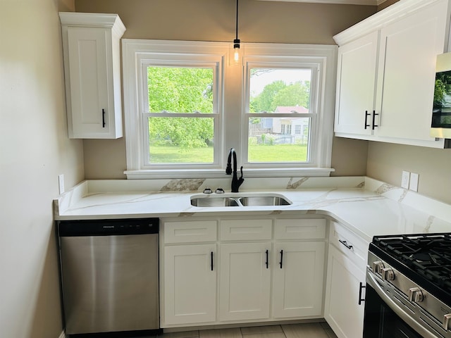 424 Tipton St S, Munford, TN 38058 - kitchen featuring white cabinets, stainless steel appliances, light stone counters, and a sink