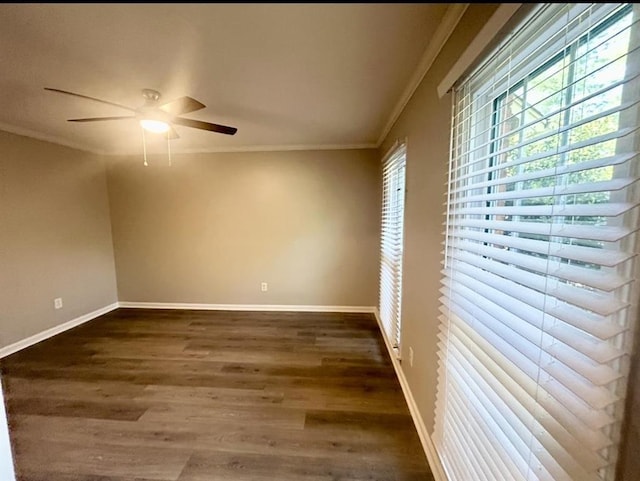 spare room with baseboards, ornamental molding, dark wood finished floors, and ceiling fan