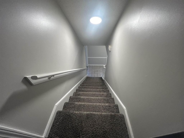 stairs featuring baseboards