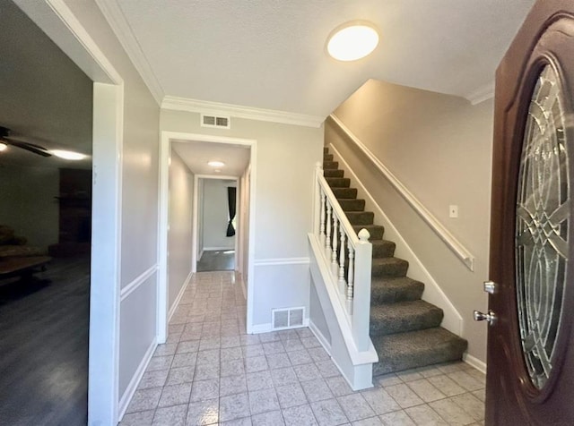 entrance foyer with baseboards, visible vents, and stairway
