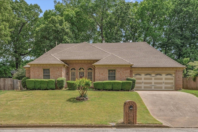 single story home featuring fence, an attached garage, a shingled roof, brick siding, and concrete driveway