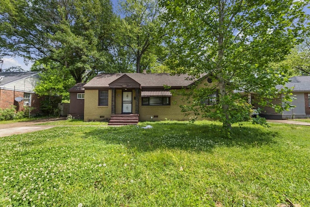 view of front of home with a front yard, brick siding, and crawl space