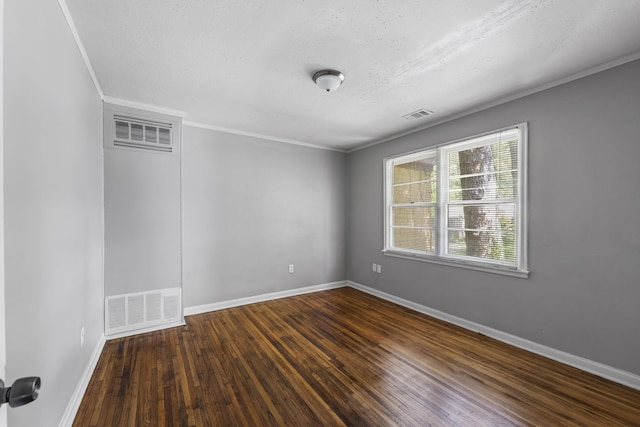spare room with visible vents, dark wood-style flooring, and baseboards