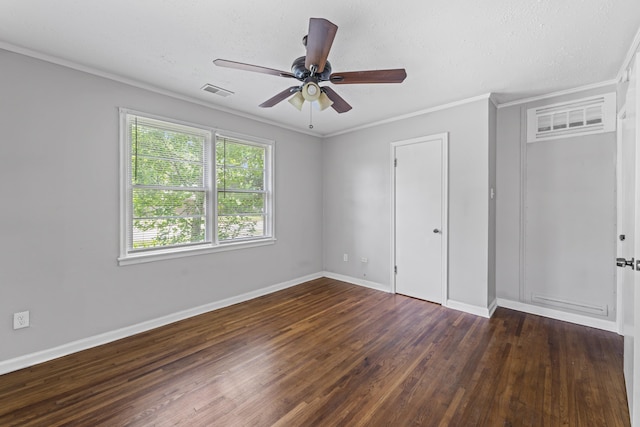 unfurnished bedroom with crown molding, visible vents, wood finished floors, baseboards, and a ceiling fan