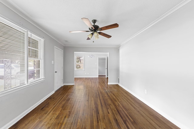 spare room with baseboards, a ceiling fan, dark wood finished floors, and ornamental molding