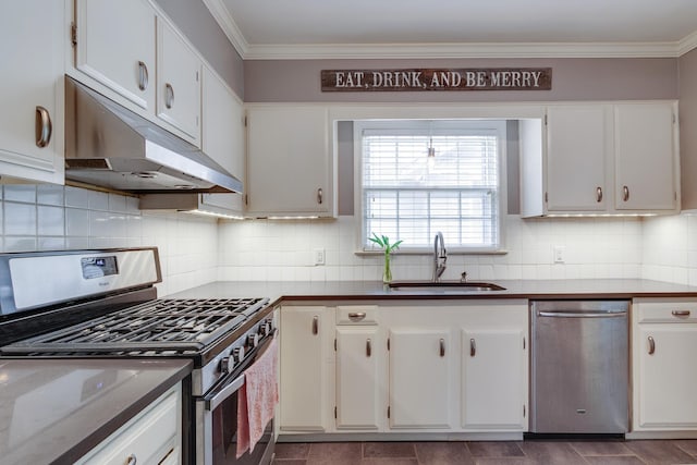 kitchen with a sink, white cabinets, under cabinet range hood, ornamental molding, and stainless steel appliances