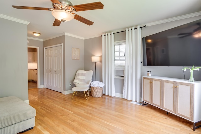 sitting room with crown molding, visible vents, baseboards, ceiling fan, and light wood finished floors