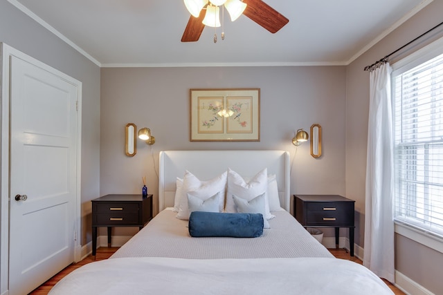 bedroom featuring baseboards, ornamental molding, a ceiling fan, and wood finished floors
