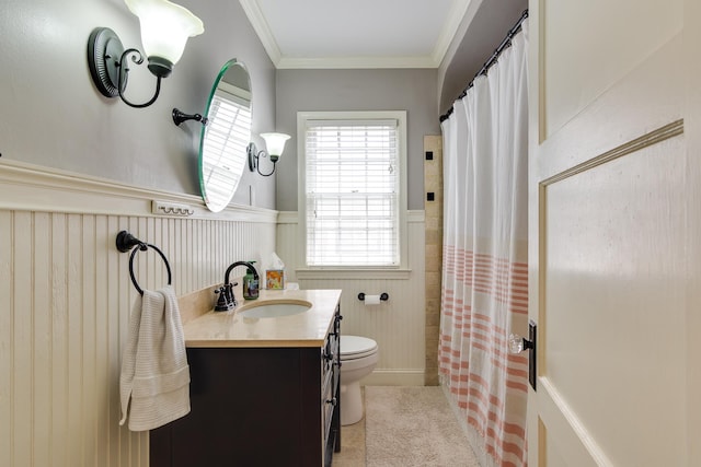 bathroom featuring wainscoting, vanity, tile patterned floors, toilet, and ornamental molding