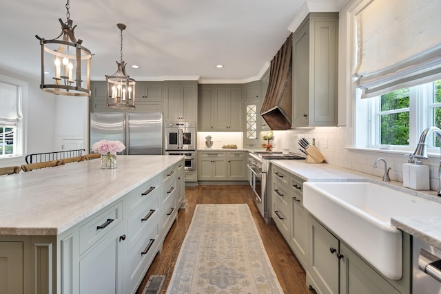 kitchen featuring backsplash, a center island, an inviting chandelier, premium appliances, and recessed lighting
