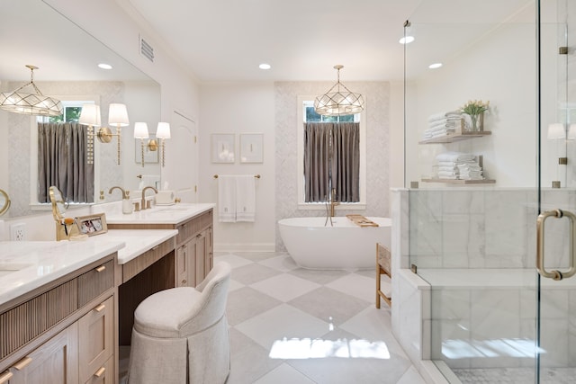 bathroom with visible vents, a shower stall, vanity, a soaking tub, and recessed lighting
