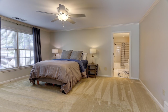 carpeted bedroom with crown molding, baseboards, visible vents, and ensuite bathroom