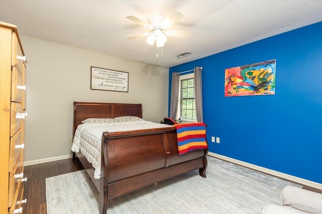 1309 Brookside Dr, Germantown, TN 38138 - bedroom featuring visible vents, wood finished floors, baseboards, a textured ceiling, and a ceiling fan