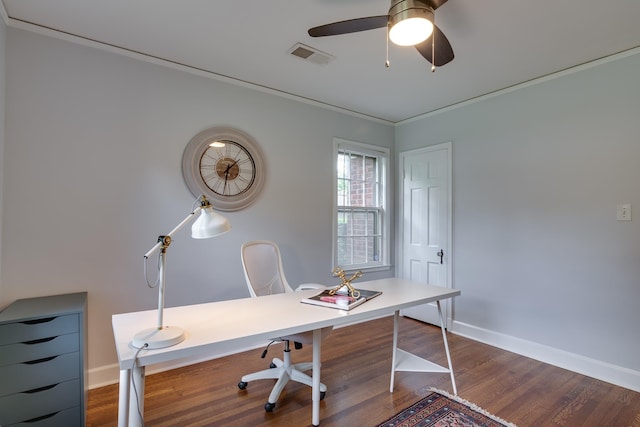 office space with ceiling fan, baseboards, dark wood-type flooring, visible vents, and ornamental molding