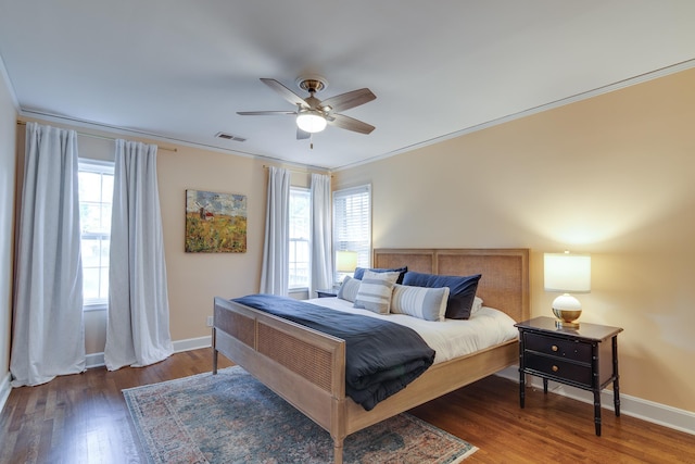 bedroom with visible vents, ornamental molding, wood finished floors, and multiple windows