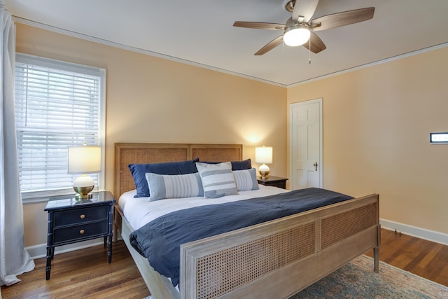 bedroom with baseboards, ornamental molding, ceiling fan, and wood finished floors