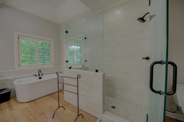 full bathroom featuring a soaking tub, a shower stall, and wood finished floors