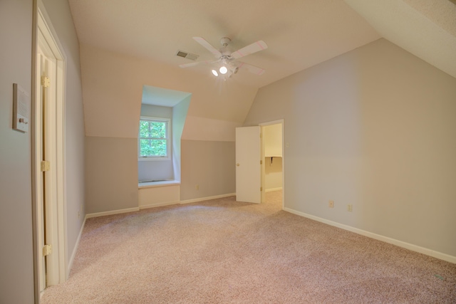 additional living space featuring visible vents, light carpet, and lofted ceiling