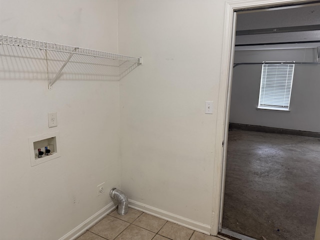 laundry room featuring laundry area, hookup for a washing machine, baseboards, and light tile patterned flooring