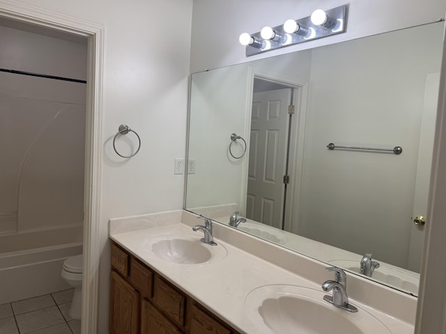 full bathroom featuring a sink, tile patterned floors, and toilet