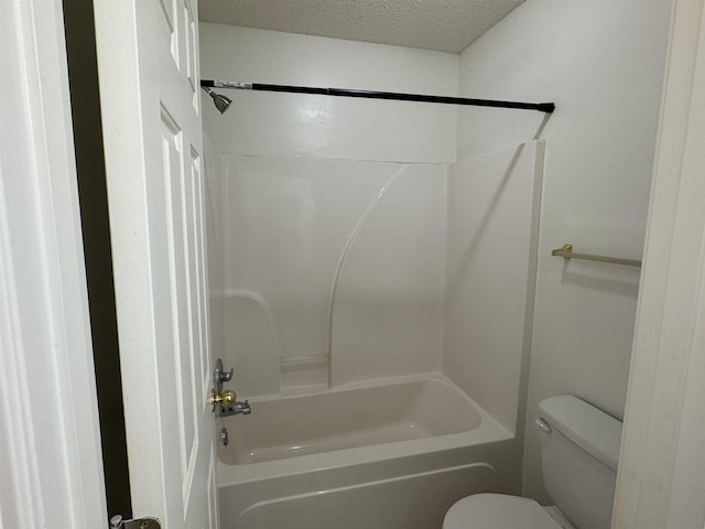 full bath featuring toilet, a textured ceiling, and bathtub / shower combination