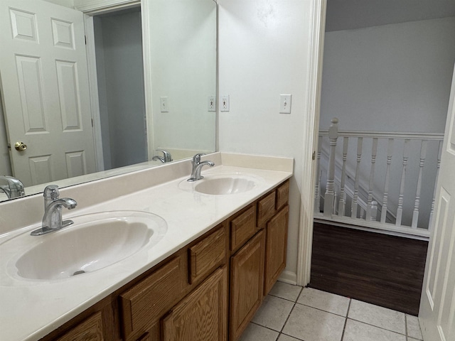 bathroom featuring double vanity, a sink, and tile patterned floors