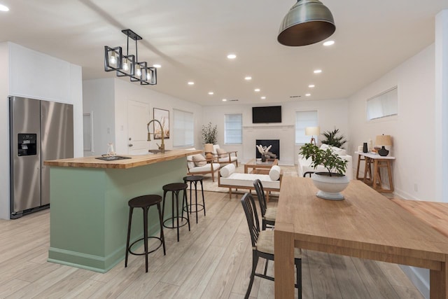 4771 Sea Isle Rd, Memphis, TN 38117 - dining area featuring light wood-style floors, a fireplace, and recessed lighting
