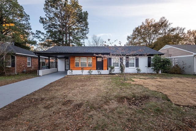 4771 Sea Isle Rd, Memphis, TN 38117 - ranch-style house with a carport, a front yard, driveway, and brick siding