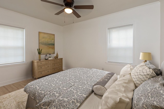 4771 Sea Isle Rd, Memphis, TN 38117 - bedroom with baseboards, a ceiling fan, wood finished floors, and multiple windows